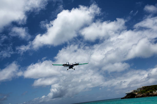 istock Small Commercial Plane Landing Over Beach 685438818