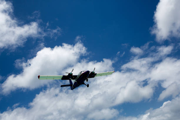 istock Small Passenger Airplane Flying Low under Beautiful Clouds 685443828