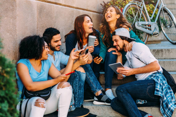 istock Friends browsing the net outdoors 685449364