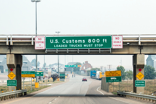 Signs indicate that drivers are approaching the U.S. Customs area in Sweet Grass, Montana near the Canadian border.