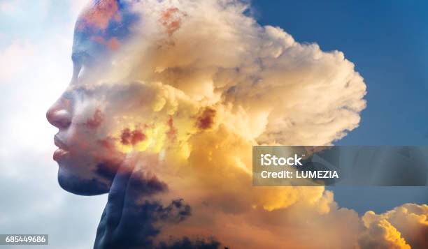 Double Exposure Closeup Of An African American Girl And Layers Of Stunning Fluffy Clouds Stock Photo - Download Image Now