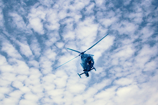 Military navy helicopter flying in the blue sky