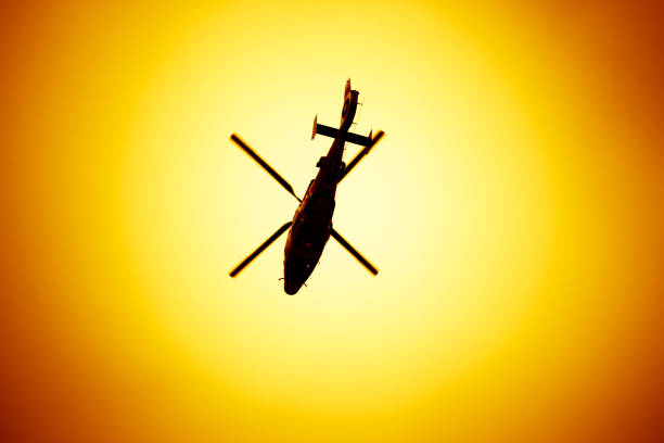 istock Big helicopter flying on a sunset background 685452498