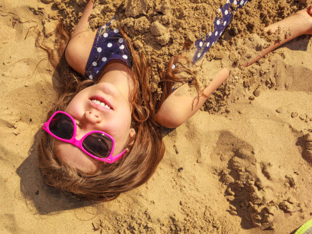 istock Lovely gorgeous little girl playing with sand. 685464564