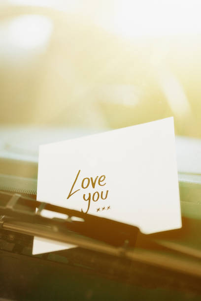 istock Tucked under windshield wiper, handwritten note says 