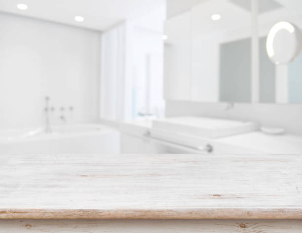 istock Background of blurred bathroom interior with wooden table in front 685470232