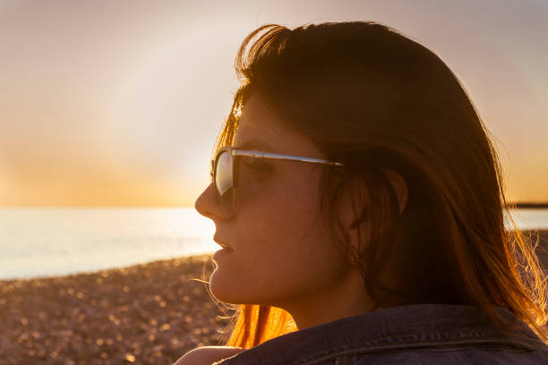 istock Young attractive woman on the beach at sunset time 685478978