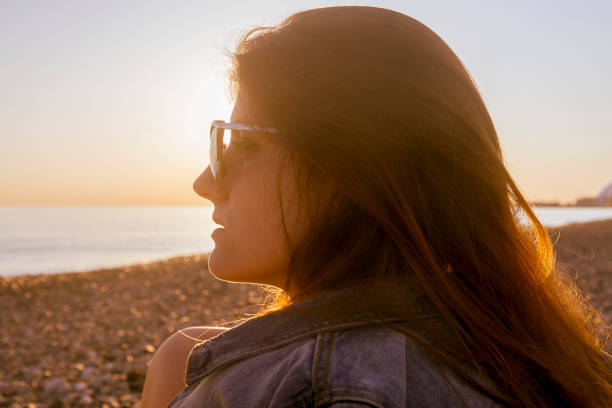 istock Young attractive woman on the beach at sunset time 685478988