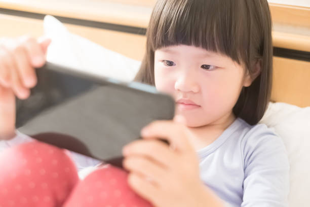 istock cute girl use phone 685479038