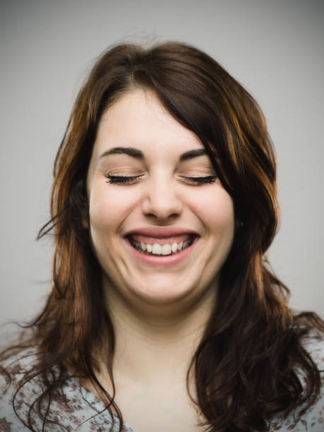 istock Real woman smiling with her eyes closed 685479214