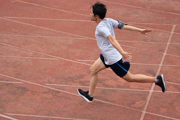 istock Athletic Asian runner sprinter crossing the finish line. 685479224