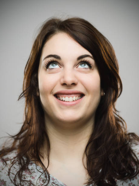 istock Real young woman looking up and smiling 685479272