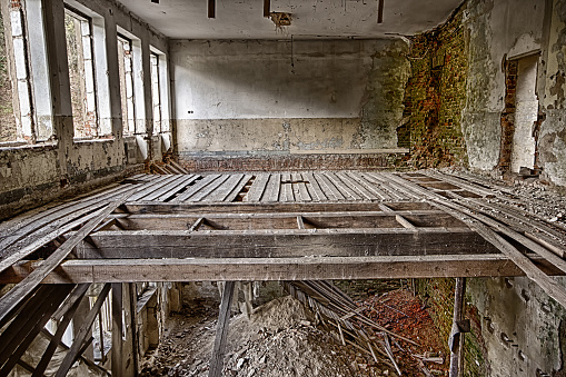 Abandoned devastated room with broken floor