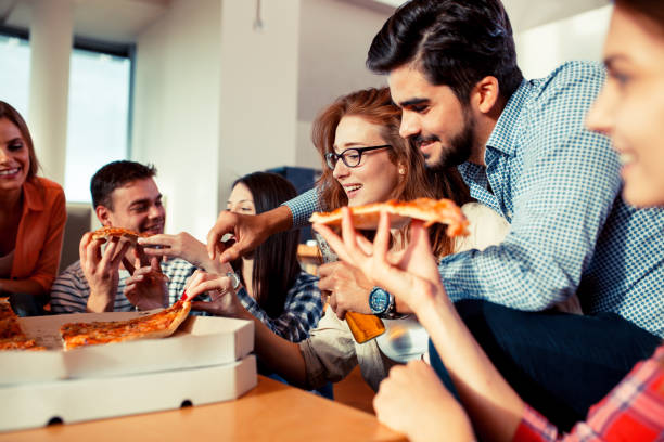 istock Group of young friends eating pizza 685489282