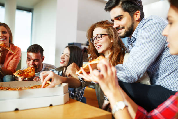 istock Group of young friends eating pizza 685489284
