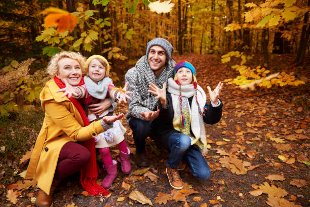 istock Kids trying to reach falling leafs 685489728