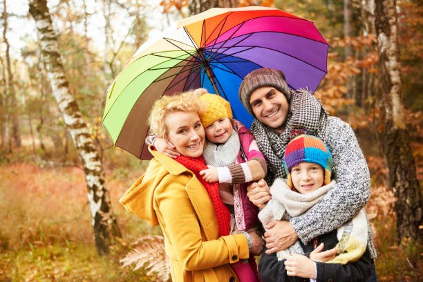 Family looking for shelter with umbrella