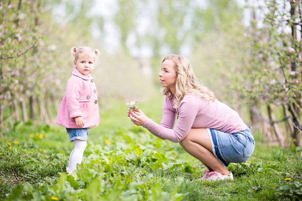 istock Mother and little daughter in a orchard 685498114