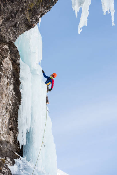 istock Side view of man ice climbing on frozen waterfall 685498788