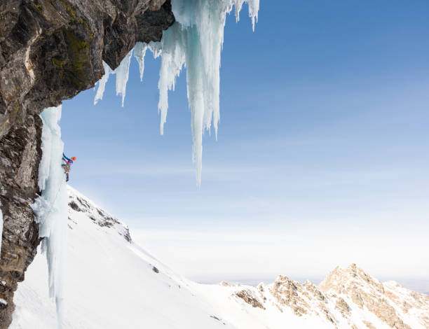 istock Anonymous male ice climber ascending on  frozen rock wall 685499362
