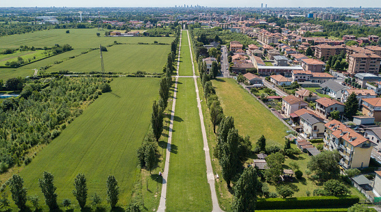 New Skyline of Milan seen from the Milanese hinterland, aerial view, tree lined avenue. Pedestrian cycle path. Varedo, Monza Brianza, Lombardy. Italy