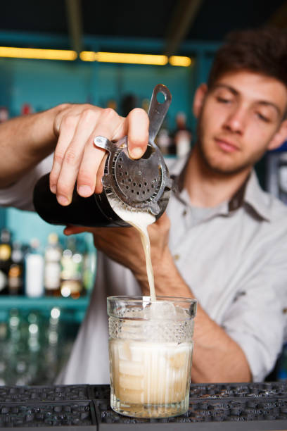istock Young Barman's making shot cocktail, pouring syrup into glass 685507116