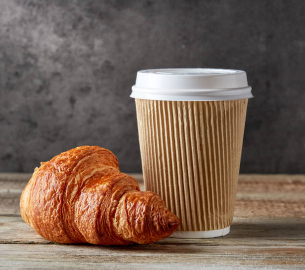 istock paper coffee cup and croissant 685512170