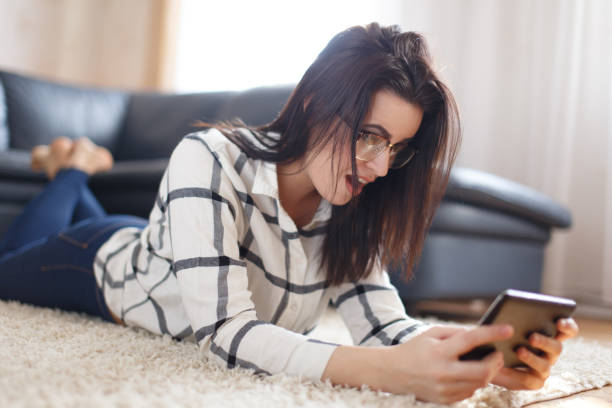 istock Young brunette woman surprised while reading message on tablet 685525900