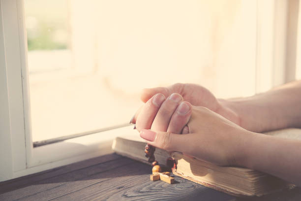 istock cross on the couple hands 685526468
