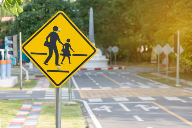 Students crossing ahead sign Students crossing ahead sign pedestrian stock pictures, royalty-free photos & images