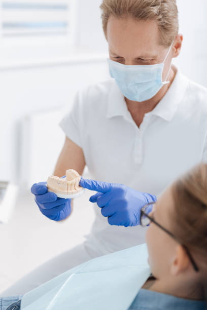 istock Clever easygoing dentist showing how procedure works 685546290