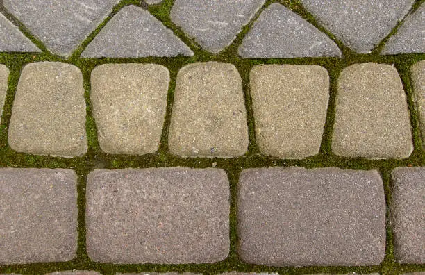 Paving-stone. / Old paving-stone, gray, pink and yellow. close-up on top of natural light.