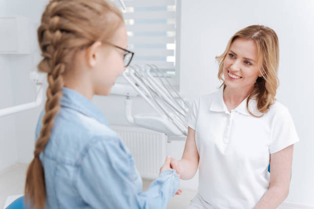 istock Lovely young dentist greeting her little patient 685555170