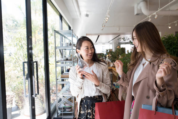 istock Two laughing girls have a transparent bottle in hand. 685562580