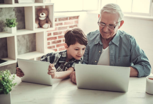 grandpa and grandson - senior adult technology child internet imagens e fotografias de stock