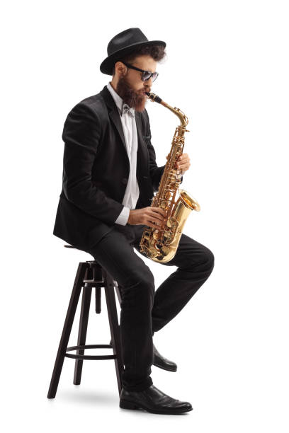istock Jazz musician playing saxophone and sitting on chair 685569088
