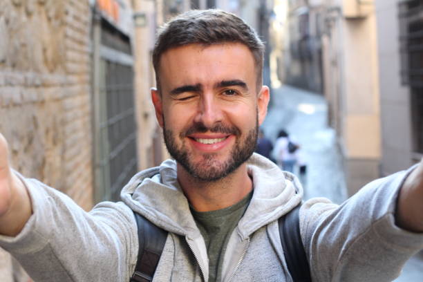 istock Handsome man taking selfie and winking outdoors 685572358