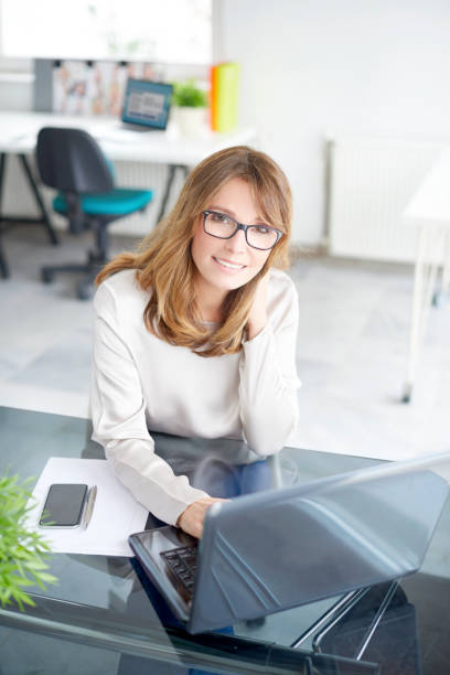 istock Smiling woman in the office 685584338