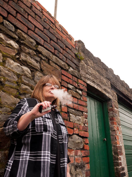 istock Mature Woman Smoking an Electronic Cigarette 685599872