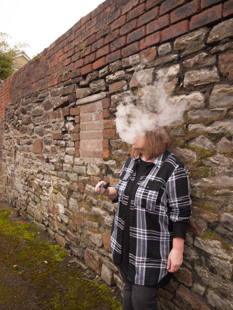 istock Mature Woman Smoking an Electronic Cigarette 685601012