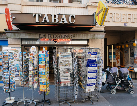 Paris: newspaper press kiosk facade with newsstand featuring headlines following the terrorist incident in London at the Westminster Bridge