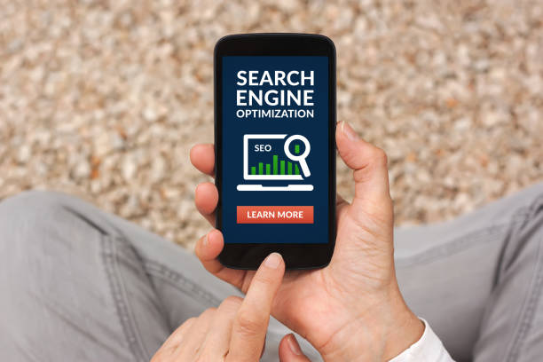 istock Hands holding smart phone with SEO concept on screen 685606356