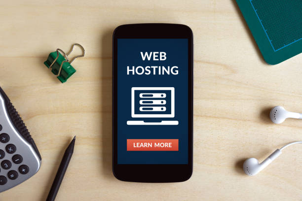 istock Web hosting concept on smart phone screen on wooden desk 685606360