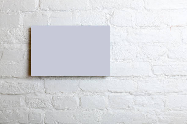 istock lilac blank poster in a white brick wall. Template Mock up for your content 685609520