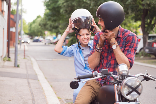 Teen boy with father and motorcycle