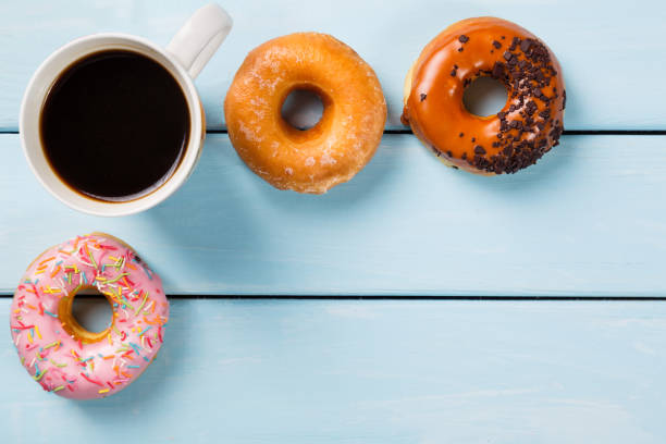istock Cup with coffee and donuts on blue wooden table. Top view and free space for your text 685631104