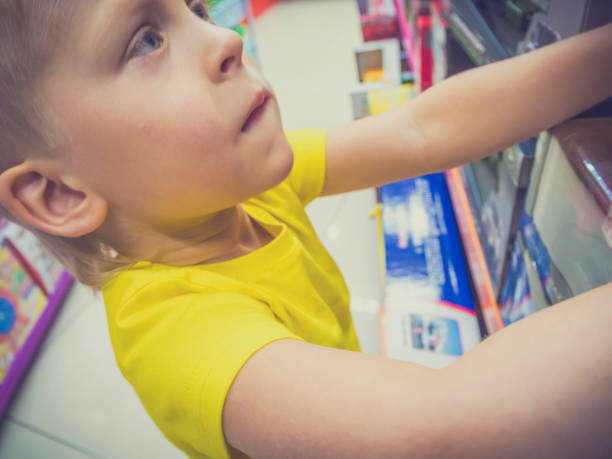 istock Boy choosing toy in the shop 685635300