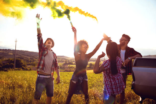 istock Friends holding smoke bombs having fun in a field 685638992