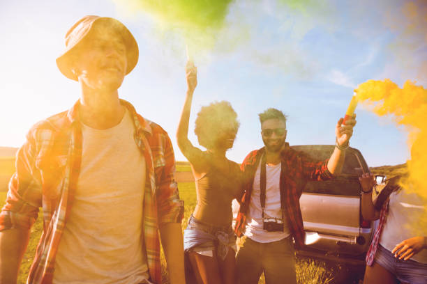 istock Friends holding smoke bombs having fun in a field 685641084