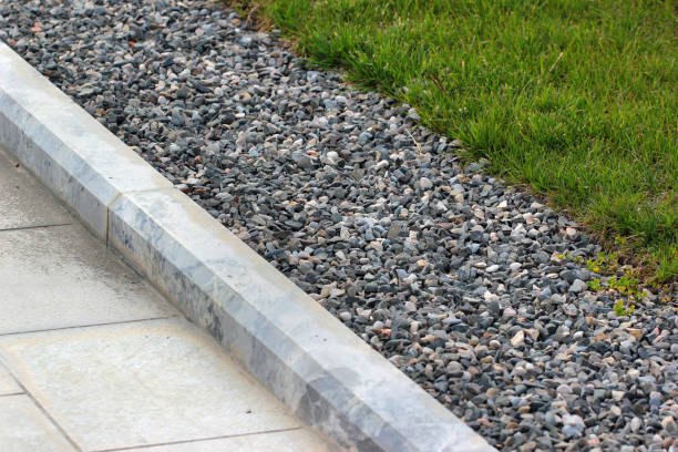 Border kerb between lawn and sidewalk in a park stock photo